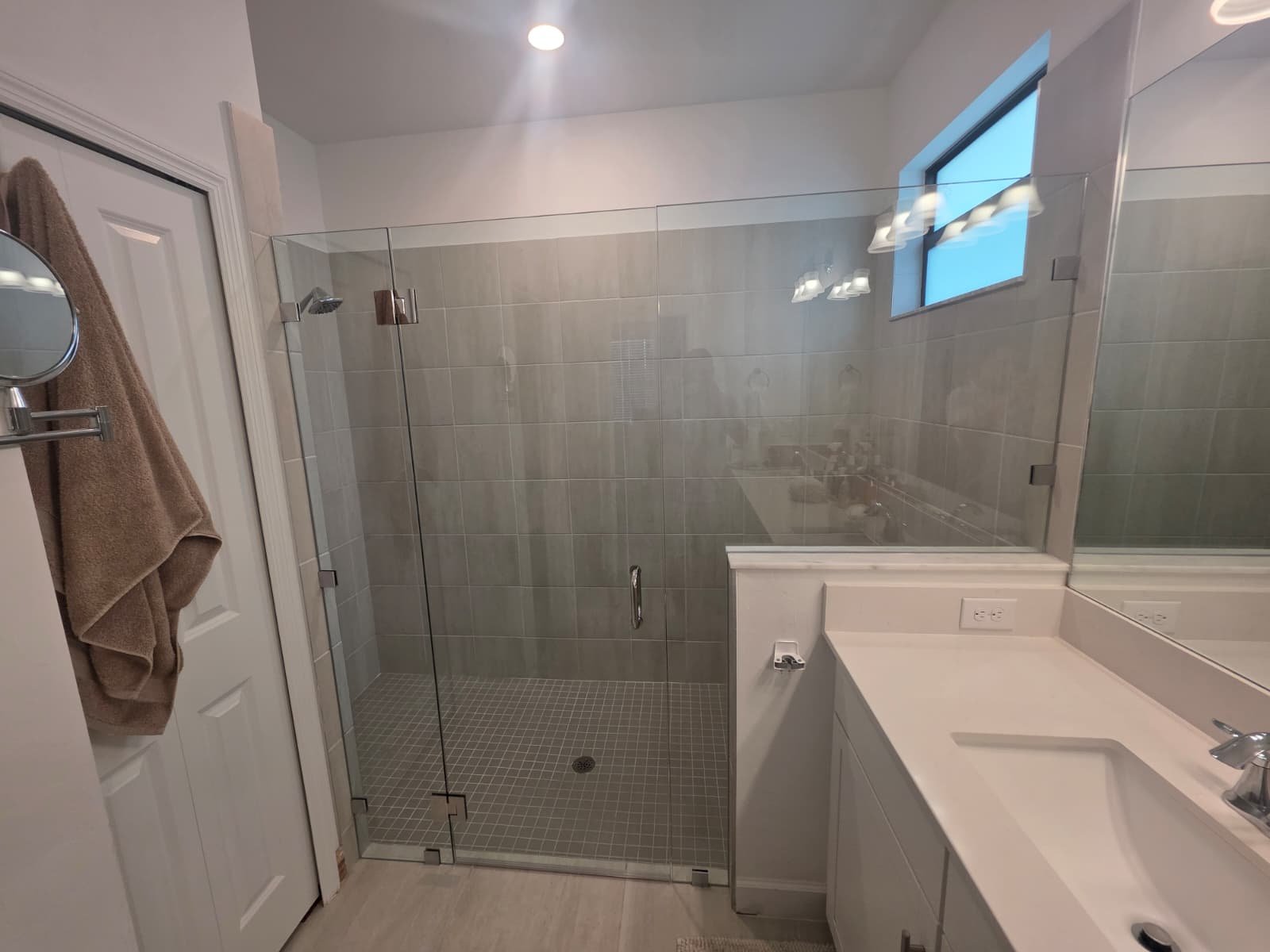 Bathroom after remodel with frameless glass shower door