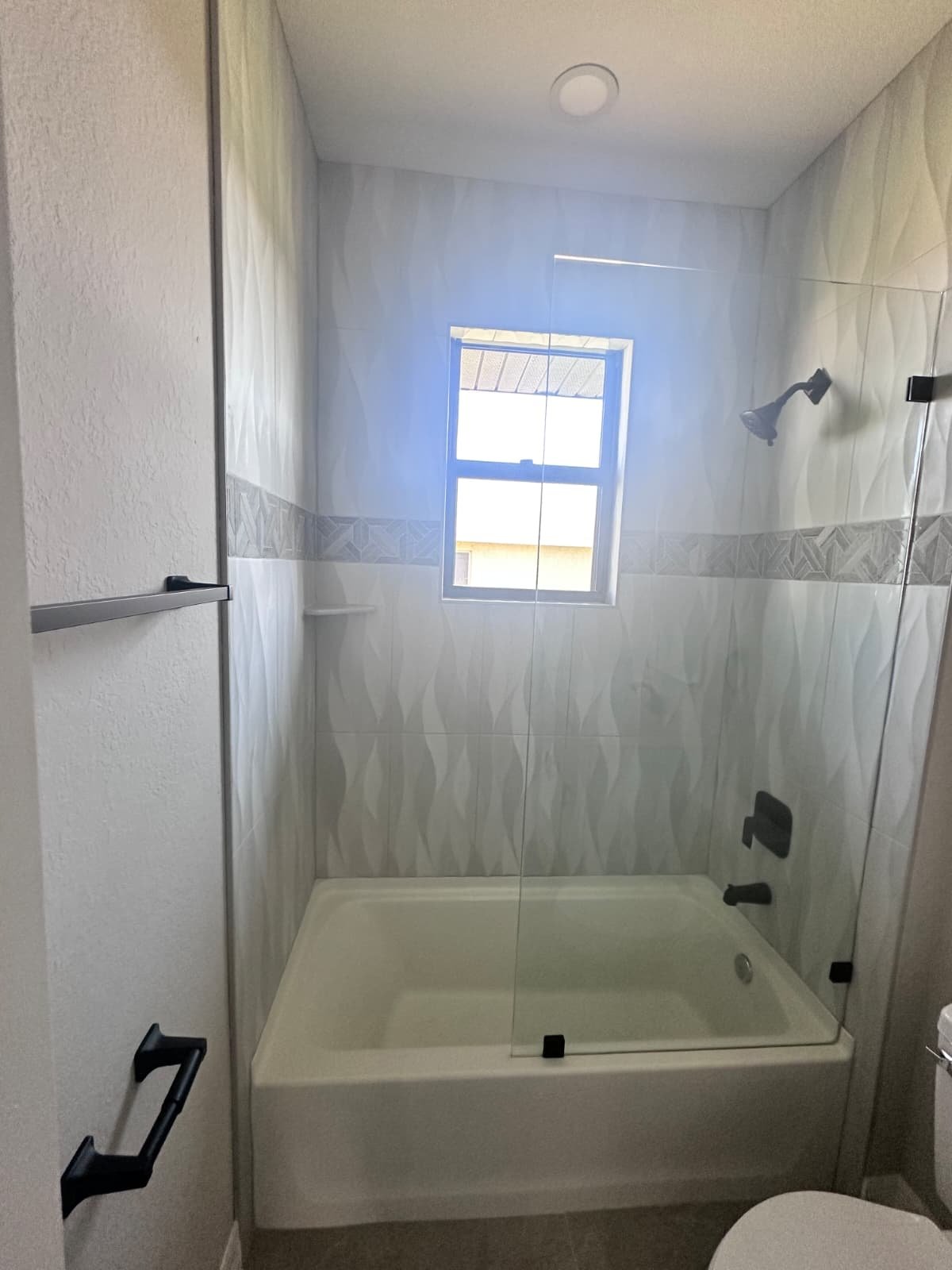 Powder room with round mirror and floating vanity